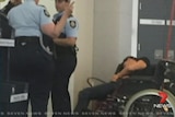 Grant Hackett slumped in wheelchair at Melbourne Airport