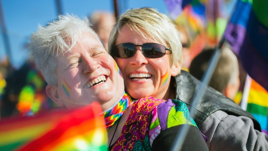 an older lesbian couple at a pride rally