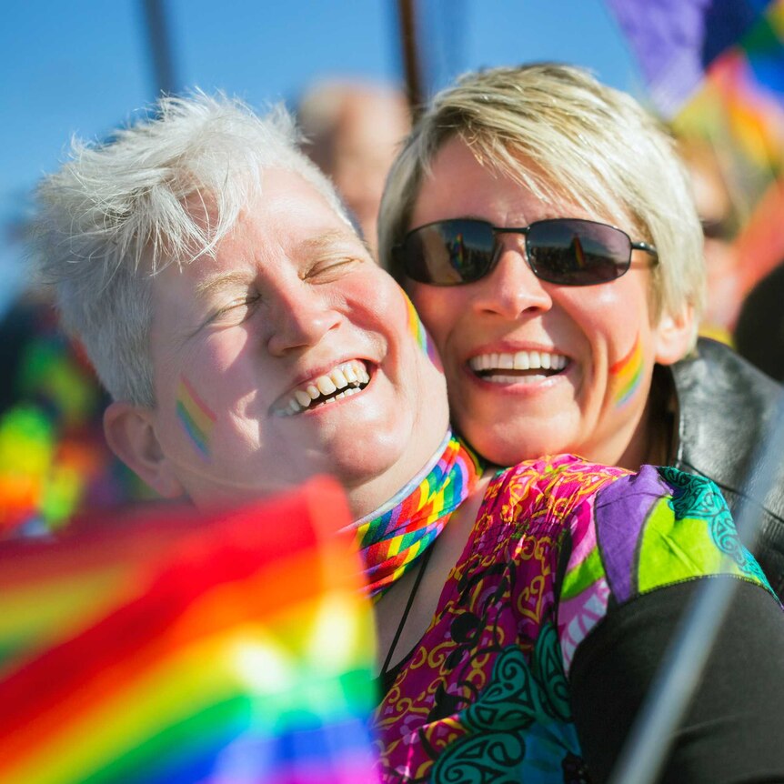 an older lesbian couple at a pride rally