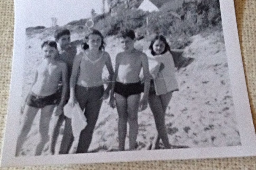black & white archival photo of a family at the beach