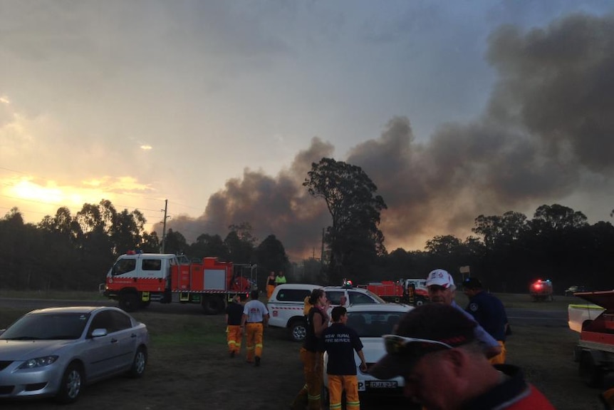 Smoke billows behind fire crews fighting the Aberdare fire at Cessnock in the Hunter region of NSW yesterday.