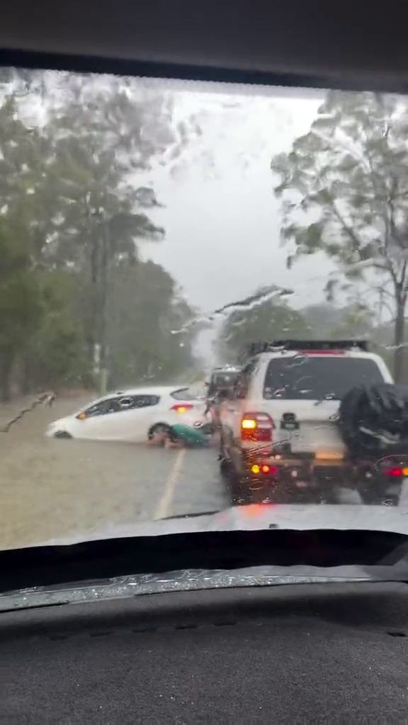 A car caught in floodwaters at Morayfield. - ABC News
