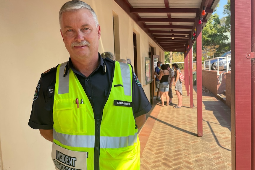 A man in a yellow vest.