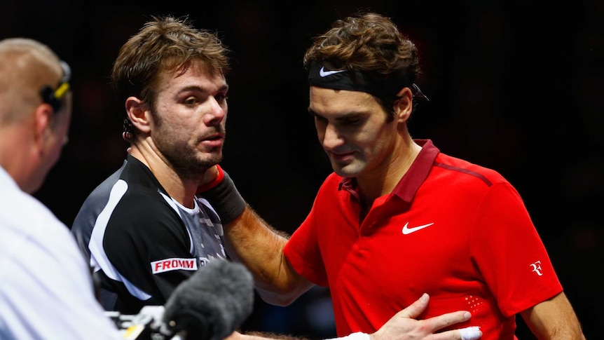 Roger Federer hugs Stanislas Wawrinka after their semi-final at the ATP World Tour Finals in London.