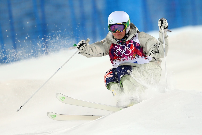 Britteny Cox skis over a bump in the Moguls final of the Sochi 2014 Winter Olympics.