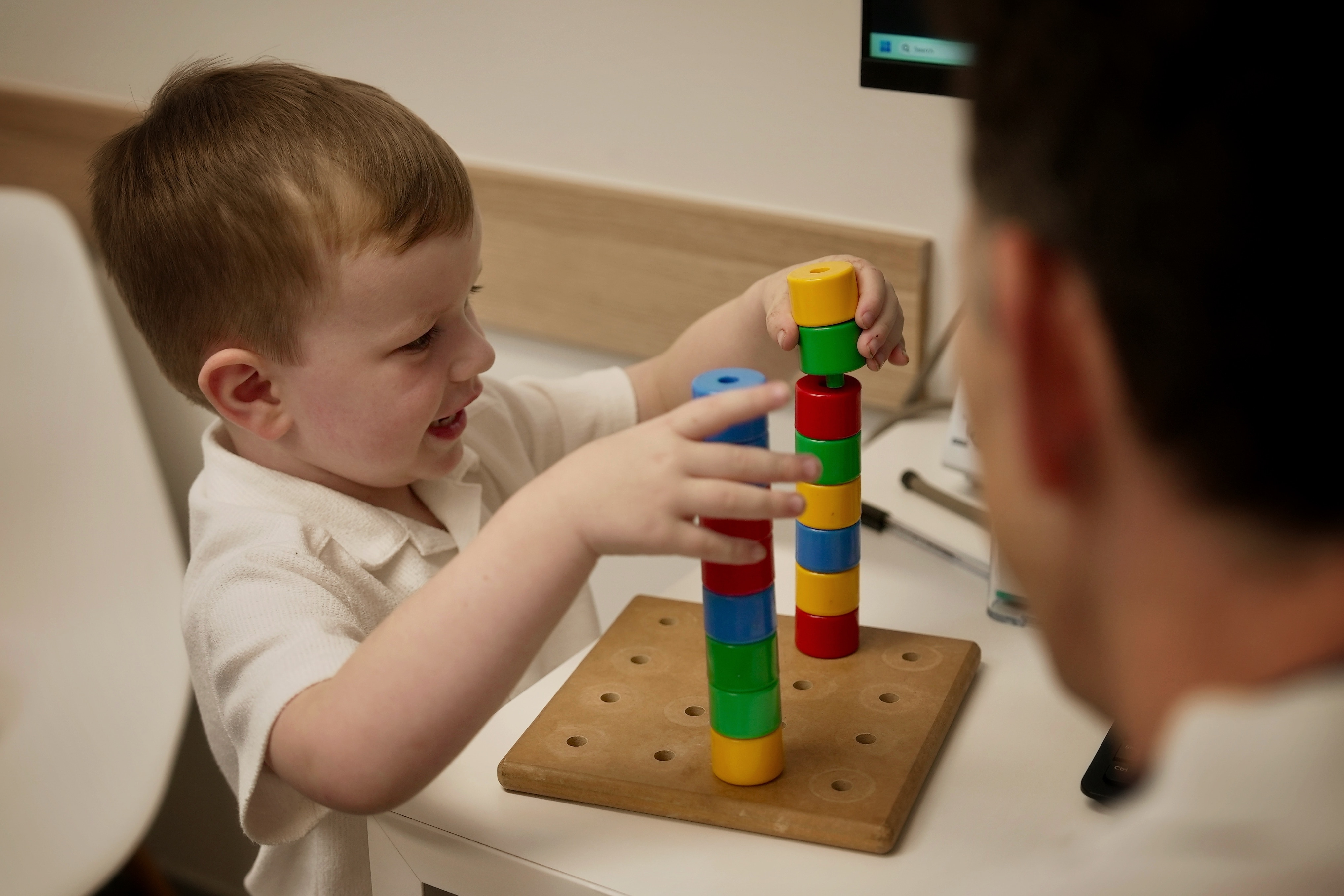 Kid playing with blocks in a doctor's office.