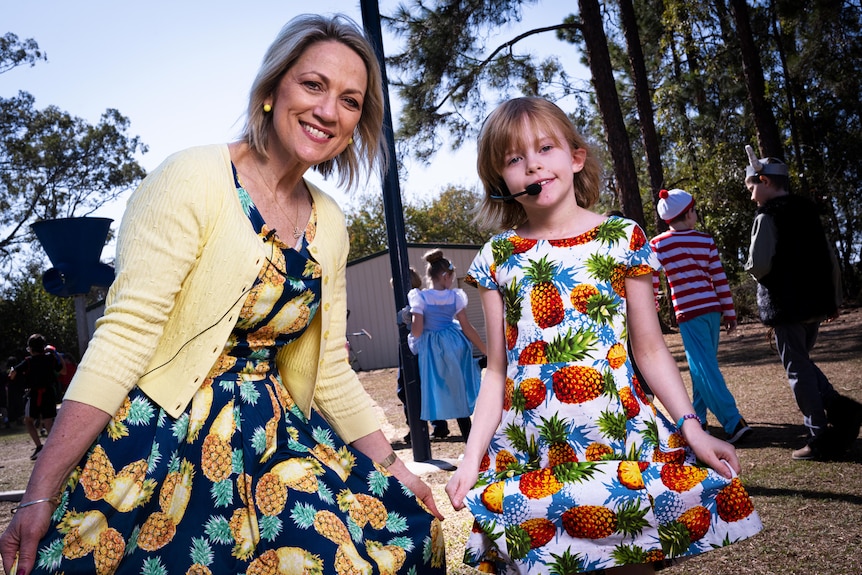 A woman and a girl with pineapple dresses