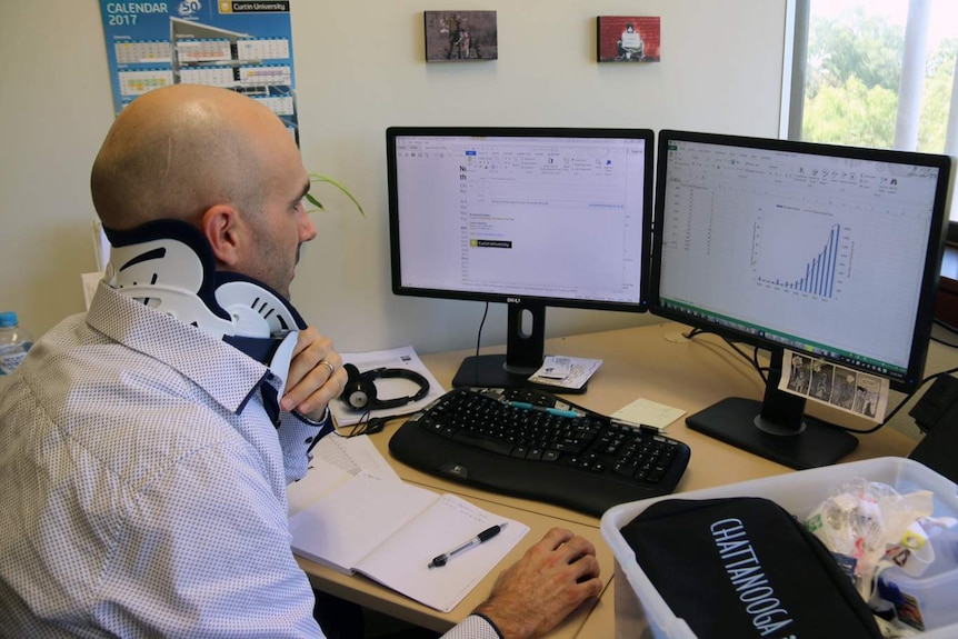 Curtin University's Dr Patrick Clarke examines study data on a computer