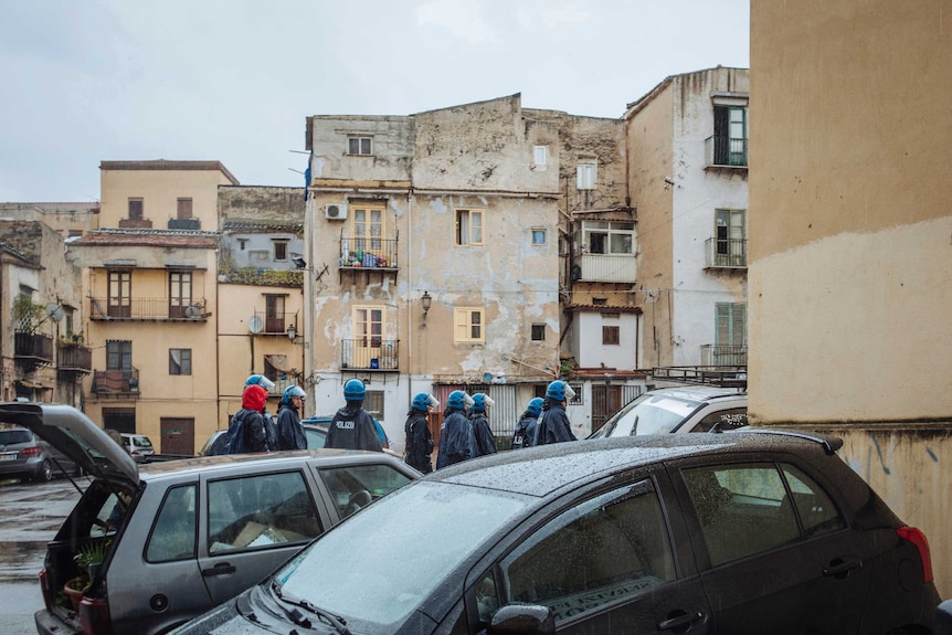 Police walk through the streets.