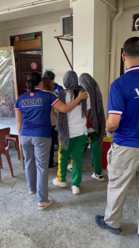 Children are escorted to safety by their rescuers