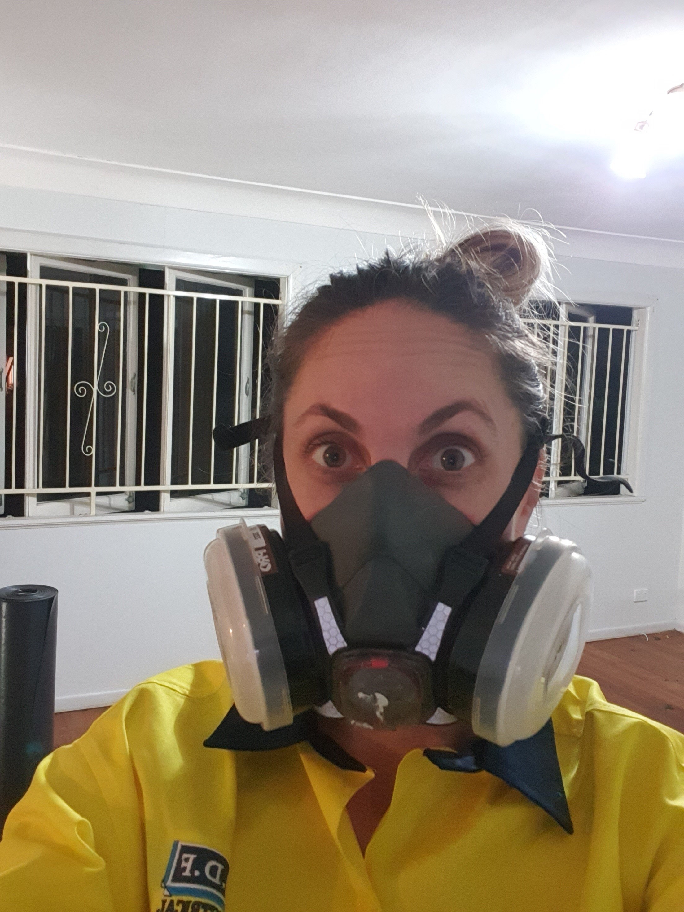 A selfie of Mackenzie wearing a dust mask during her renovation