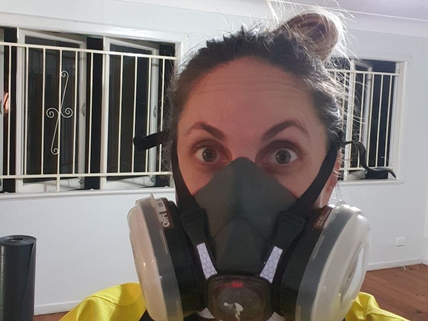 A selfie of Mackenzie wearing a dust mask during her renovation