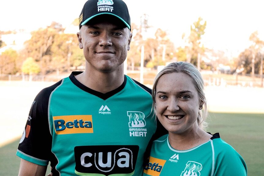 Both in full Brisbane Heat playing kit, Jack and Georgia Prestwidge stand arm in arm and smile