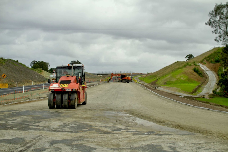 Roller machine working on newly laid road of the Pacific Highway in Northern New South Wales.
