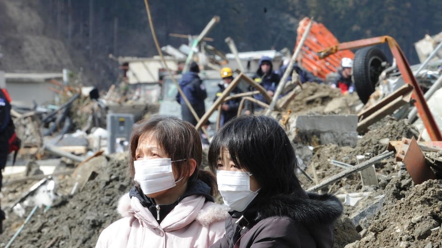 Two women survey the damage in Japan's earthquake-ravaged Minamisanriku on March 18.