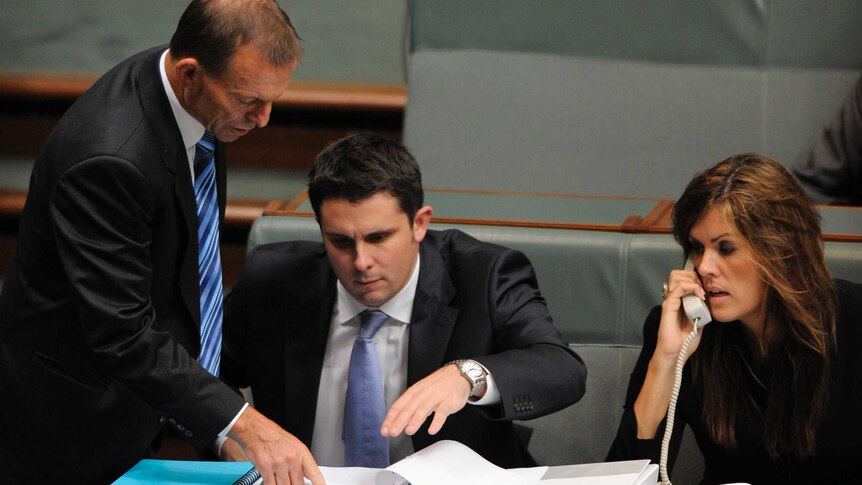Then Opposition Leader Tony Abbott talks with advisers Andrew Hirst and Peta Credlin (right) during Question Time.