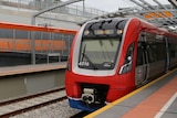 A train at the platform of a station.