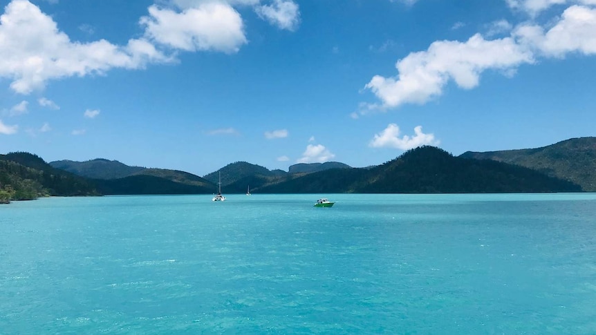 Three boats in the distance in Cid Harbour.