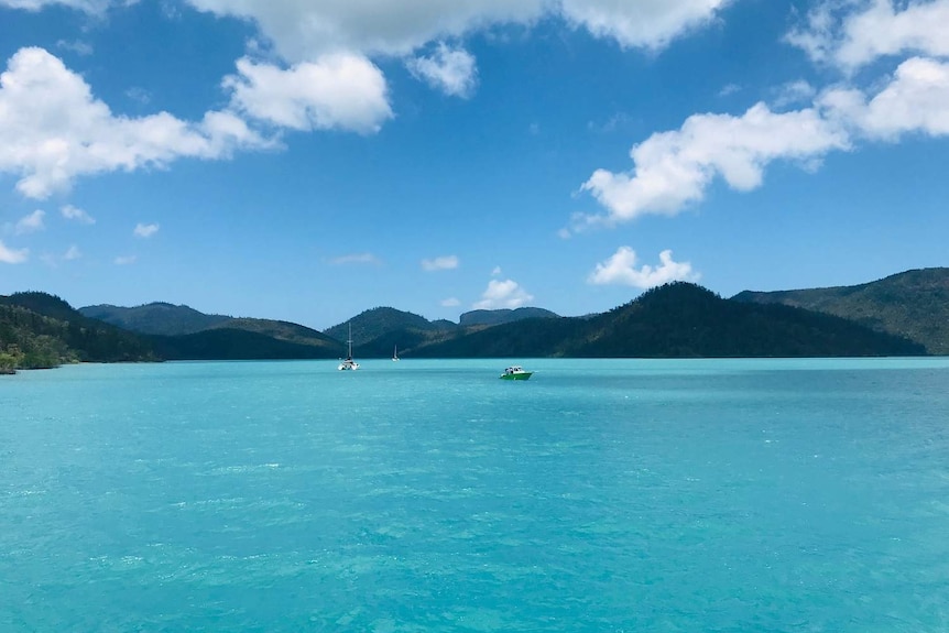 Three boats in the distance in Cid Harbour.