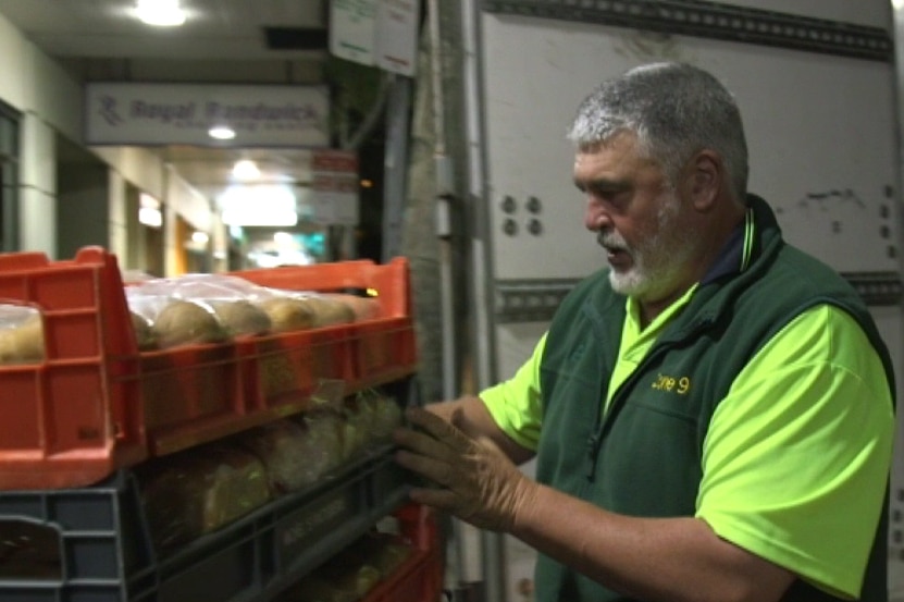 Graeme Wong pushes crates of bread as part of a delivery in the early hours of the morning