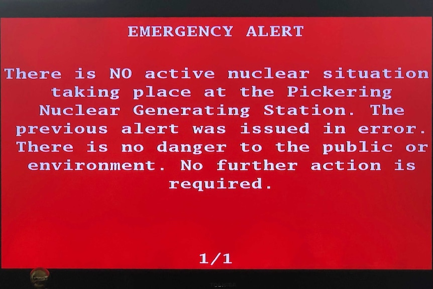 A red emergency alert with white text is shown on a tv screen clarifying there is no active nuclear situation taking place