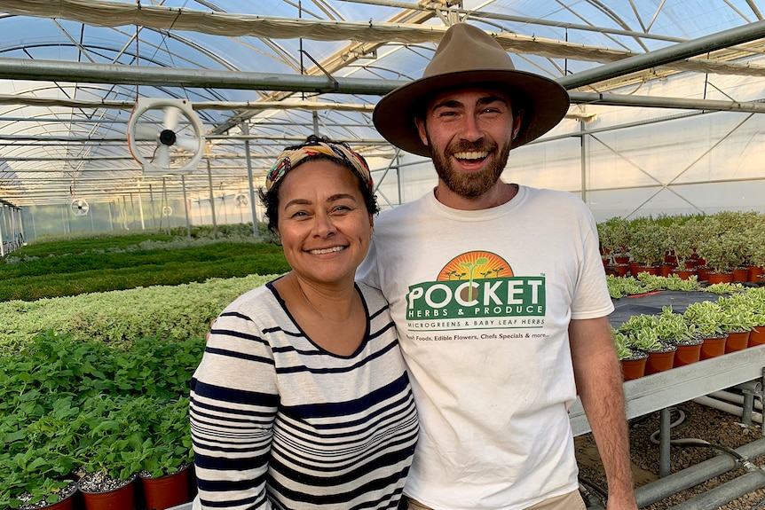 Arabella Douglas with Leon Reynolds in the greenhouse at Pocket Herbs.