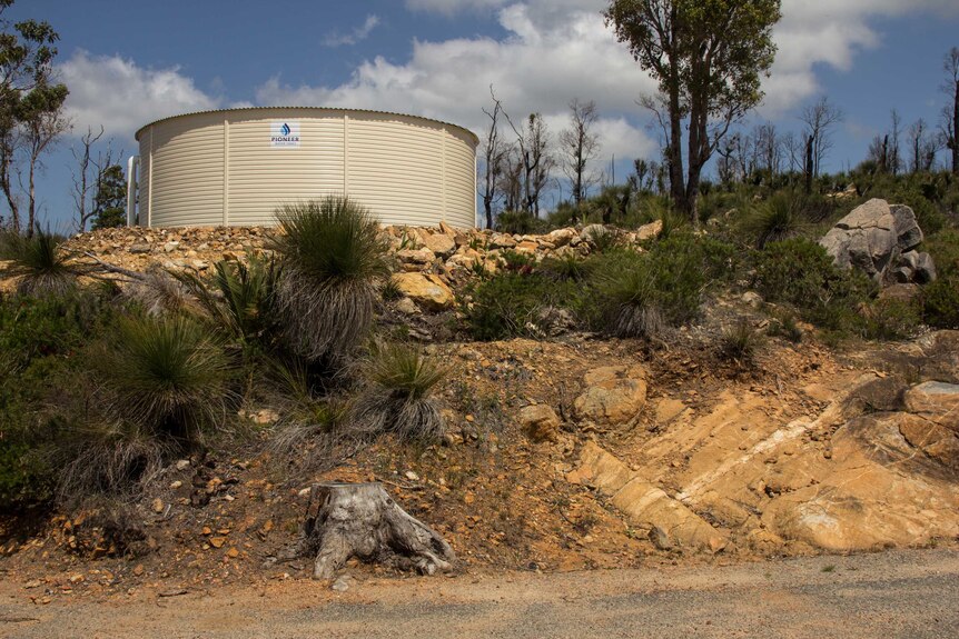 Steve Angel's water tank, which saved the property in 2016 but sustained considerable fire damage.