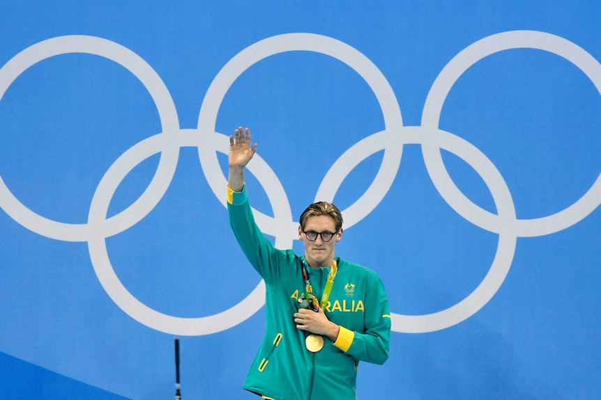 Mack Horton holds up his arm in celebration after winning gold in the men's 400m freestyle in Rio.