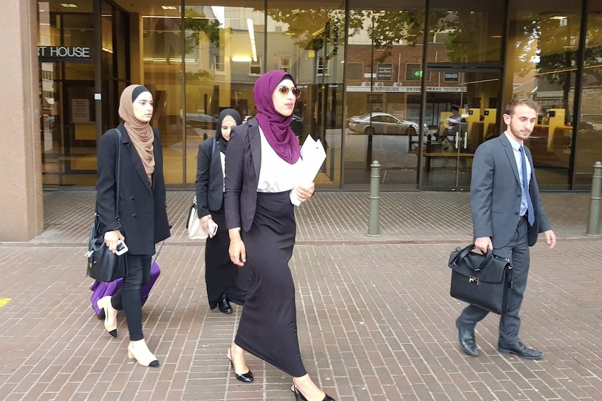 Three women and one man outside Parramatta Local Court