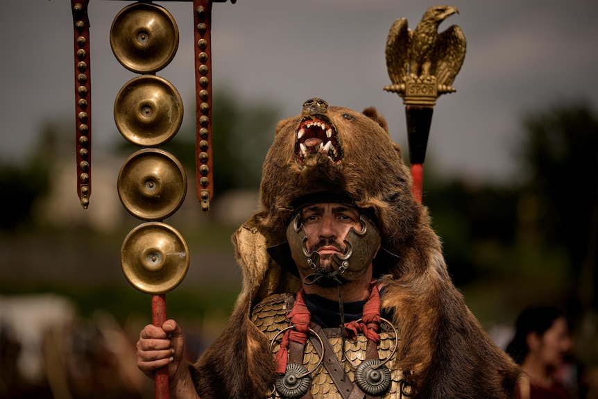 Participant in a Roman legion uniform and a bear fur