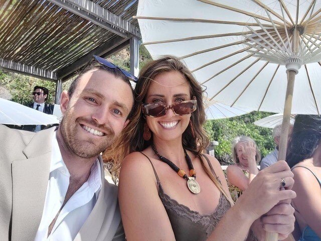 A young couple pose for a photo.