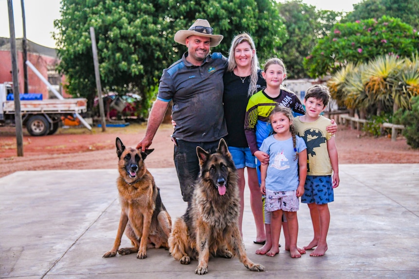 The Moore family and their dogs standing in a driveway