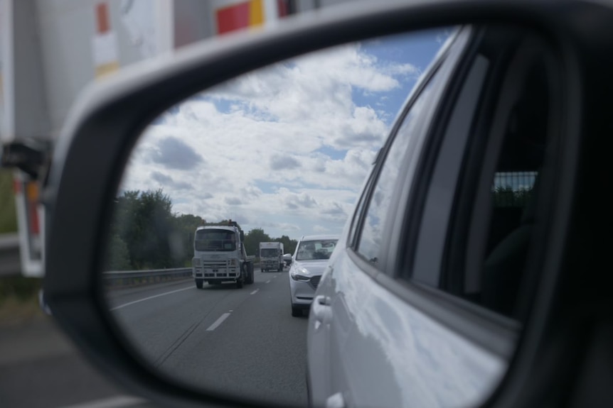 Traffic in a rear vision mirror.