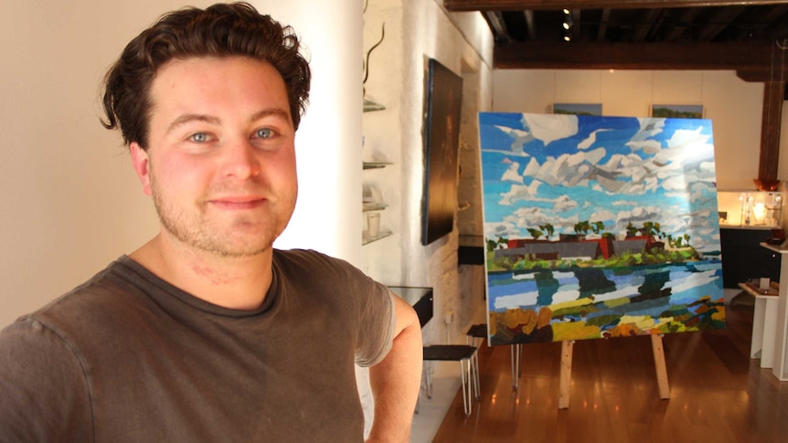 Launceston artist Josh Foley standing in front of his painting of MONA. 13 August 2014.