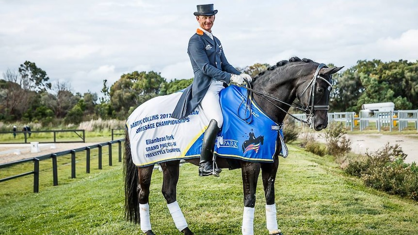 Dressage rider Brett Parbery mounted on his horse in an equestrian training facility.