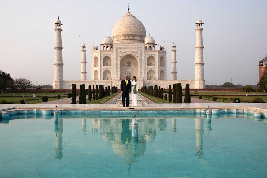 Donald Trump and Melania Trump stand in front of the Taj Mahal.