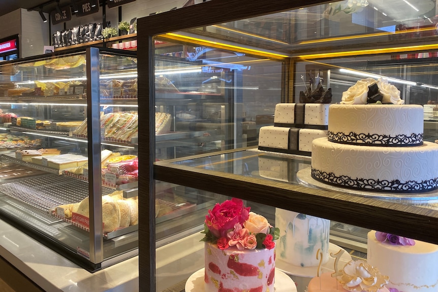 a shelf of cakes in a fridge