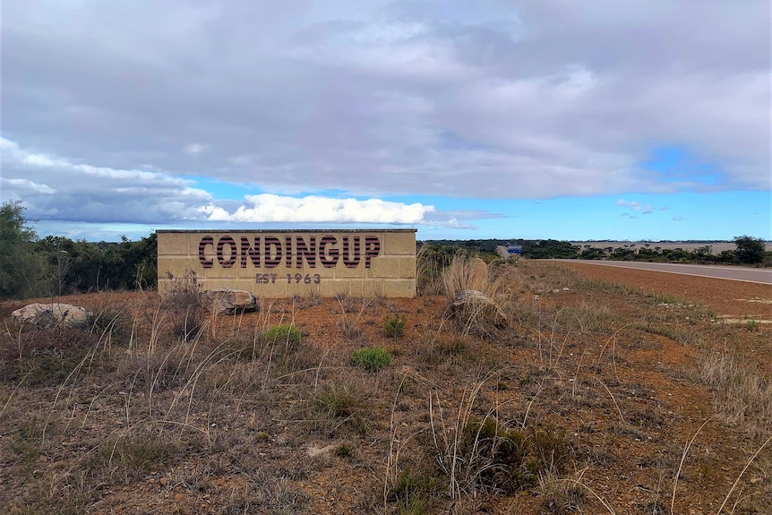 'Condingup, Est 1963' is written in corrugated iron lettering and is on a stone sign