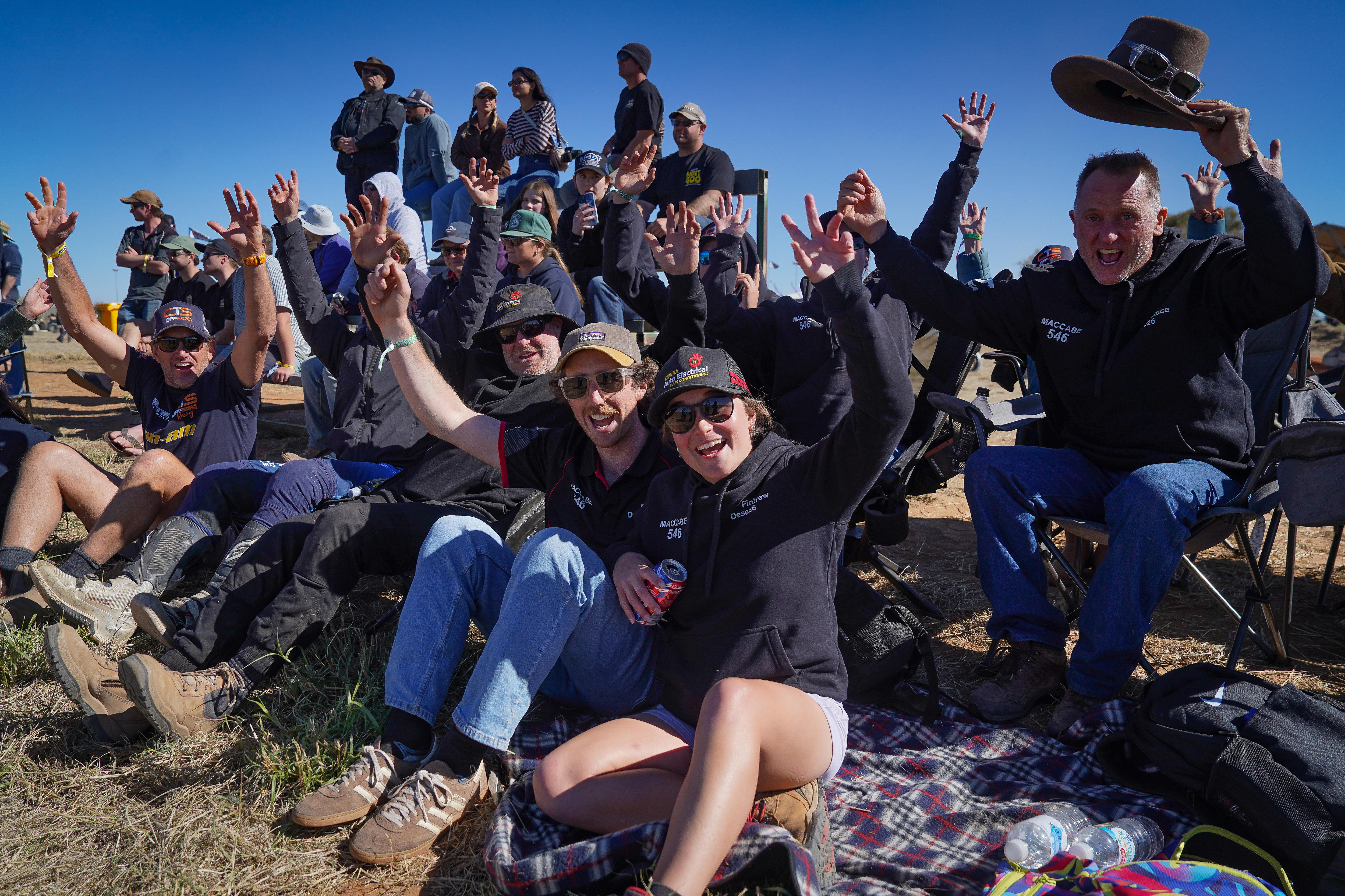 A crowd of spectators cheering from the sidelines.