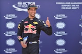 Daniel Ricciardo celebrates in the parc ferme during the qualifying session