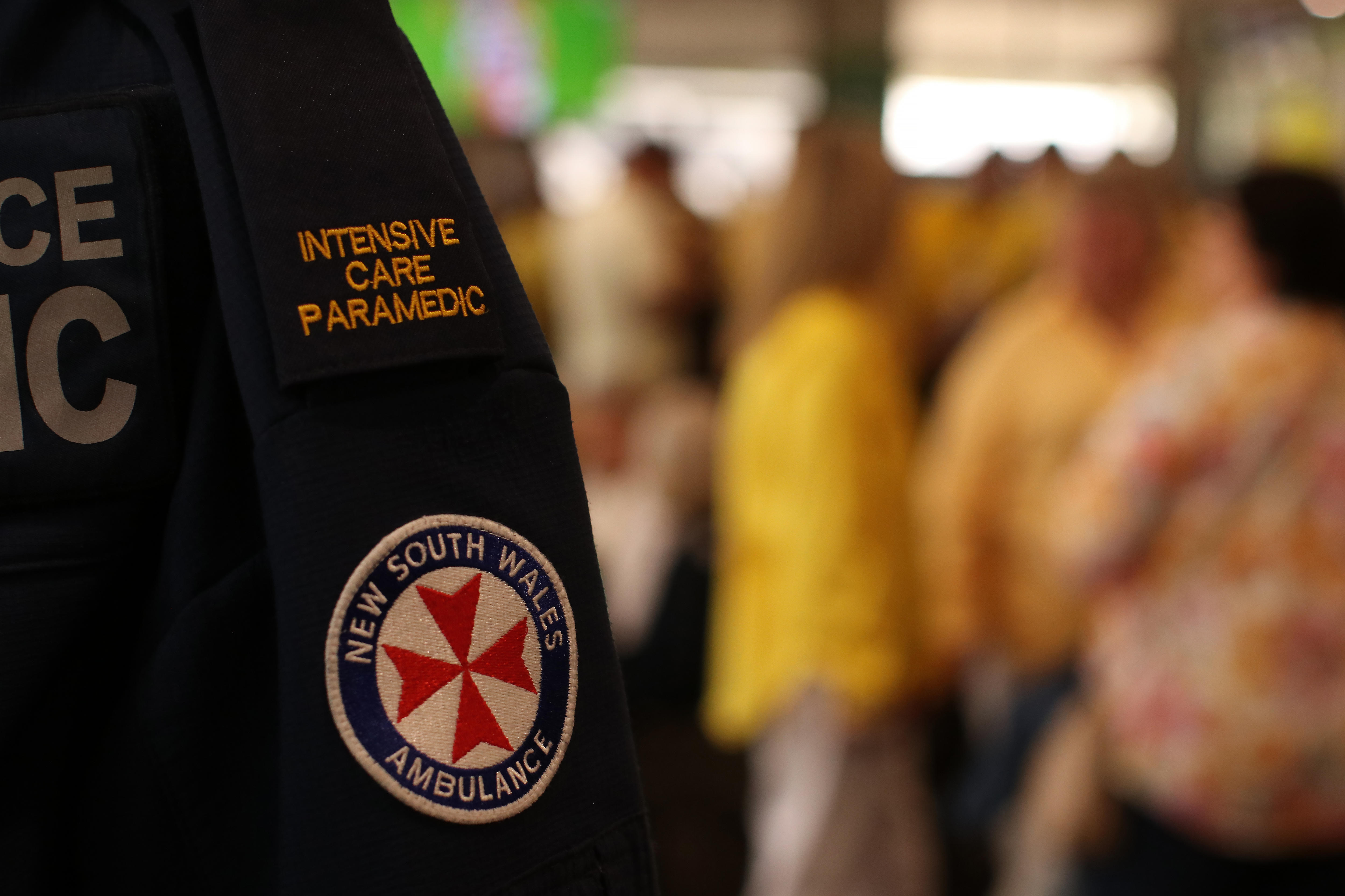 A paramedic shirt with crowd in the back ground.