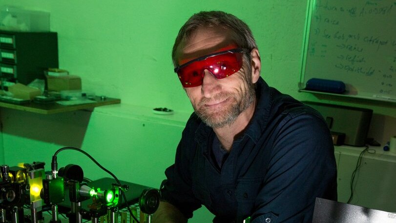Richard Mildren stands in a lab