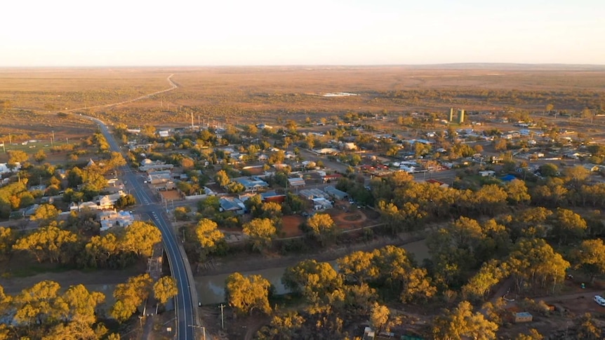 An aerial photo of Wilcannia streets lined with houses and trees.