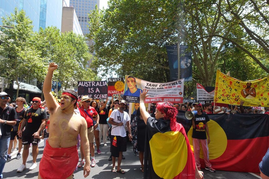 Invasion Day protesters march through Sydney.