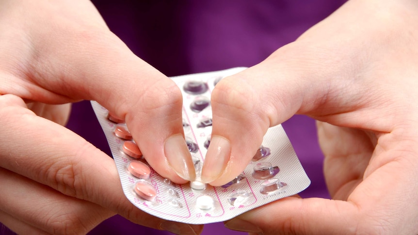 Closeup woman's hands with pack contraceptive pills