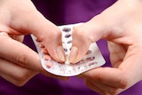 Closeup woman's hands with pack contraceptive pills