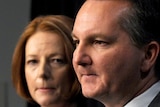 Prime Minister Julia Gillard listens to Immigration Minister Chris Bowen during a press conference in Canberra.