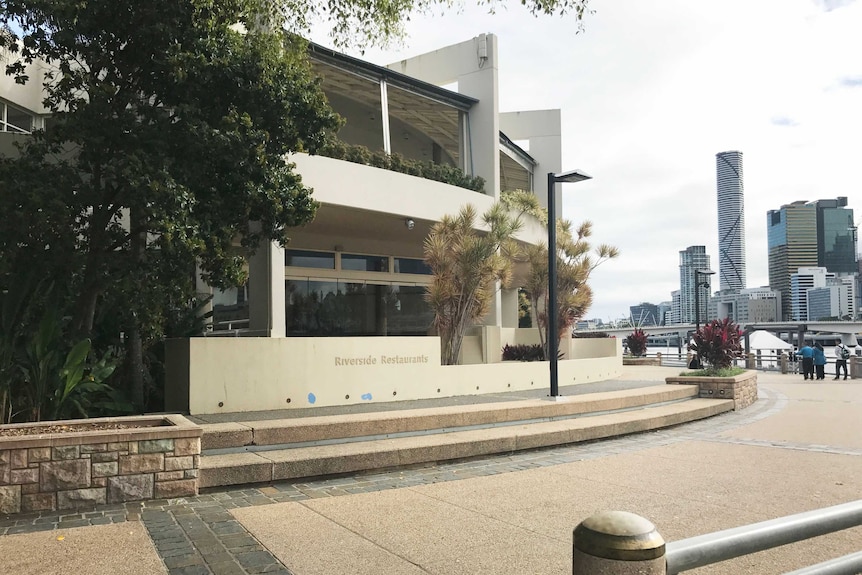 An abandoned restaurant along Southbank with cityscape in the background.