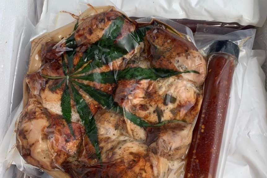 A piece of roasted chicken with a marijuana leaf on top
