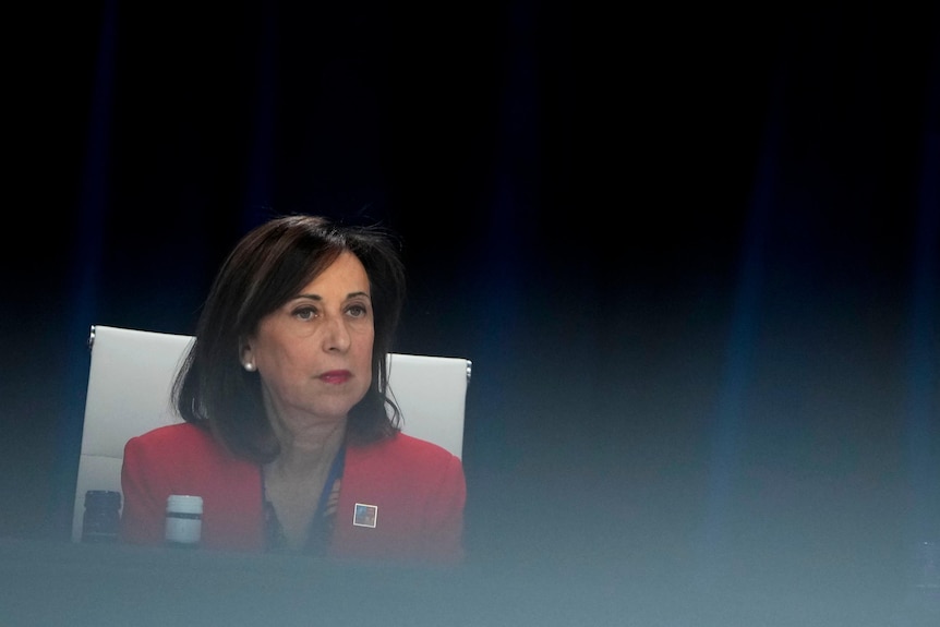 Spanish Defense Minister Margarita Robles in a red blazer.